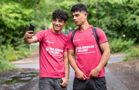 Two of the Guildford residents taking a selfie together. They are both wearing a pink YMCA DownsLink Challenge t-shirt